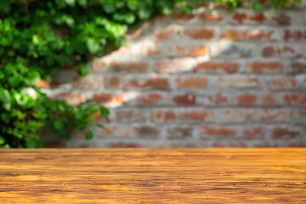 Wooden Table with Brick Wall Background   